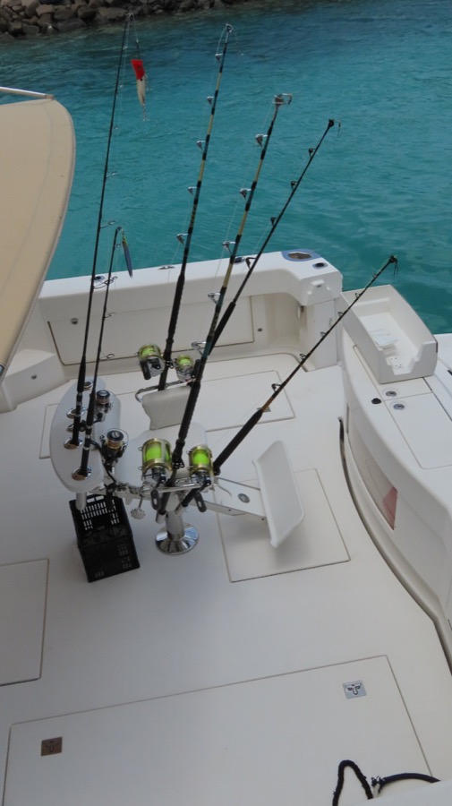 Fishing rods beside turquoise water