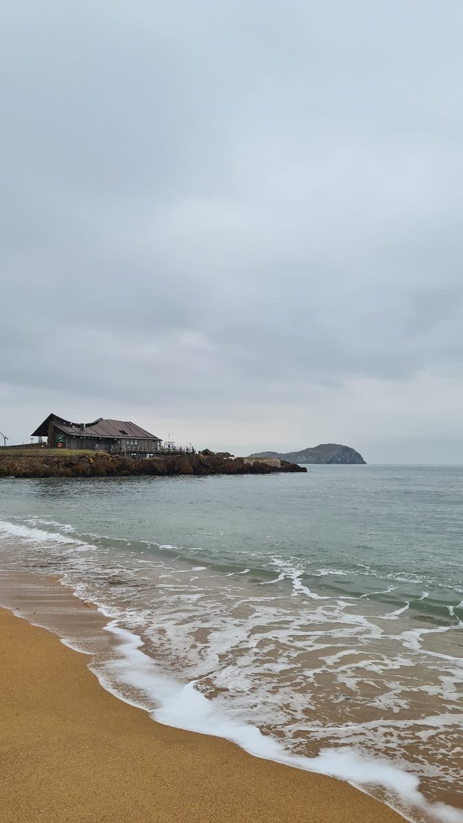 Beach shoreline beside a coastal resort building